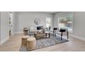 Bright and airy living room featuring modern furniture, neutral tones, and a large window at 8801 E 16 Ave, Denver, CO 80220
