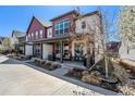 Attractive townhome boasting a covered front porch and well-maintained landscaping at 5251 Central Park Blvd, Denver, CO 80238