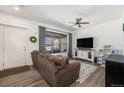 Bright living room showcasing a comfortable sofa, modern TV console, and stylish decor at 5251 Central Park Blvd, Denver, CO 80238
