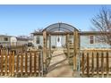 Inviting front yard view featuring a quaint walkway leading to a charming light blue home at 441 Johnson St, Frederick, CO 80530