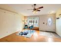 Bright living room with a ceiling fan, hardwood floors, and a cozy seating area near the front door at 441 Johnson St, Frederick, CO 80530