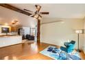 Open-concept living area showcasing hardwood floors and views into the kitchen and adjacent sitting area at 441 Johnson St, Frederick, CO 80530
