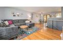 Bright living room with hardwood floors, stylish furniture, and natural light at 6147 Jellison Way, Arvada, CO 80004