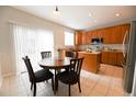 Eat-in kitchen featuring stainless appliances, warm wood cabinetry and a sliding glass door at 16738 E 106Th Pl, Commerce City, CO 80022