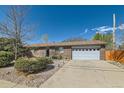 A well maintained single-story brick home with a two-car garage, a long driveway, and minimal landscaping at 125 S Fulton Ave, Fort Lupton, CO 80621
