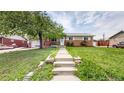 Wide angle view showing home exterior with brick facade and well-maintained lawn at 11261 Clarkson St, Northglenn, CO 80233