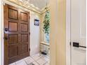 Welcoming entryway with a solid wood door, tiled floor, and a convenient shoe rack with coat hooks at 2684 S Adams St, Denver, CO 80210