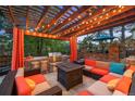 Outdoor living area with a built-in grill, fire pit, and comfortable seating at 7717 S Grape Ct, Centennial, CO 80122