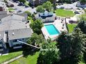 Aerial view of condo complex featuring pool and well maintained landscaping at 10150 E Virginia Ave # 13-204, Denver, CO 80247