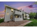 Exterior of well maintained condo building features balconies, landscaping, and ample parking at 10150 E Virginia Ave # 13-204, Denver, CO 80247