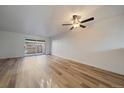 Bright living room featuring light wood floors, neutral walls, sliding glass doors and a ceiling fan at 1028 Coronado Pkwy # C, Denver, CO 80229