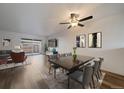 Bright, spacious living room with wood floors, modern furnishings, ceiling fan, and a sliding glass door to the patio at 1028 Coronado Pkwy # C, Denver, CO 80229