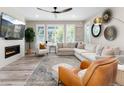 Cozy living room with a fireplace, large windows, and comfortable seating area at 6643 Barnstead Dr, Castle Pines, CO 80108