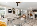 Bright living room features a large sectional sofa, stylish decor, and lots of natural light at 6643 Barnstead Dr, Castle Pines, CO 80108