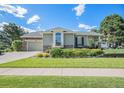 Charming single-Gathering home featuring a well-manicured lawn and stone accents on a beautiful day at 16929 W 63Rd Ln, Golden, CO 80403