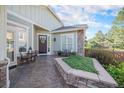 Inviting front porch with stone accents, seating area, and stylish decor elements at 16929 W 63Rd Ln, Golden, CO 80403