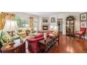 Cozy living room with a brick fireplace, plush seating, and decorative shelving at 16929 W 63Rd Ln, Golden, CO 80403