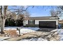 Ranch style home with a two-car garage and mature trees at 3150 S Jasper Way, Aurora, CO 80013