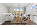 Bright living room with sliding glass doors, contemporary furniture, and a stone fireplace for a modern feel at 4355 Cyan Cir # E, Castle Rock, CO 80109