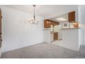 Bright dining area adjacent to the kitchen, featuring a stylish chandelier at 14171 E Jewell Ave # 203, Aurora, CO 80012