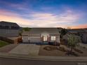 Charming home with a well-manicured lawn, three-car garage, and neutral-toned siding creating excellent curb appeal at 1034 Halfmoon Dr, Castle Rock, CO 80104