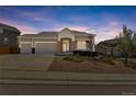 Attractive single-Gathering home with well-maintained landscaping, a three-car garage and a welcoming entrance at 1034 Halfmoon Dr, Castle Rock, CO 80104
