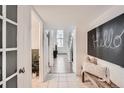 Inviting entryway featuring tiled floor, painted board trim, and unique welcome chalkboard at 108 W Byers Pl # 106, Denver, CO 80223
