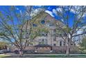 Historic Byers School No. 1 features detailed brickwork and symmetrical design, framed by mature trees at 108 W Byers Pl # 106, Denver, CO 80223