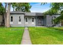 Charming gray home with well-maintained lawn and inviting walkway at 2737 N Marion St, Denver, CO 80205