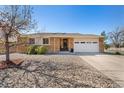 Charming single-story home with brick facade, well-maintained landscaping, and a two-car garage at 9998 W 70Th Pl, Arvada, CO 80004
