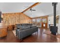 Bright living room with hardwood floors, wood-beamed ceilings, and a cozy wood-burning stove at 9998 W 70Th Pl, Arvada, CO 80004