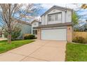 Inviting two-story home features a double garage, light gray siding and a well-manicured lawn in a serene neighborhood at 1842 Reliance Cir, Superior, CO 80027
