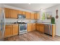 Bright kitchen features stainless steel appliances, light wood cabinets and marbled countertops at 1842 Reliance Cir, Superior, CO 80027