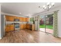 Spacious kitchen with stainless steel appliances, wood cabinets, and adjacent dining area with backyard access at 1842 Reliance Cir, Superior, CO 80027