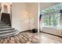 Inviting living room with high ceilings, large windows, and staircase at 1842 Reliance Cir, Superior, CO 80027