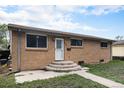 Charming single story brick home with a well-maintained front yard and concrete steps to the front door at 547 S 3Rd Avenue, Brighton, CO 80601