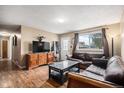 Inviting living room boasts hardwood floors and comfortable sofas, perfect for lounging and hosting guests at 547 S 3Rd Avenue, Brighton, CO 80601