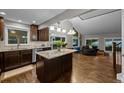 Open concept kitchen with hardwood floors, island, and stainless steel appliances at 15220 E Caley Ave, Centennial, CO 80016