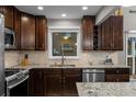 Spacious kitchen with granite countertops, backsplash, and stainless steel dishwasher at 15220 E Caley Ave, Centennial, CO 80016