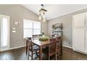 Cozy dining area featuring a wooden table, seating for six, and ample natural light from a large window at 5264 E 129Th Pl, Thornton, CO 80241