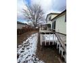 Spacious backyard showcasing a wooden deck and fenced yard, perfect for outdoor entertaining at 14989 E Pacific Pl, Aurora, CO 80014