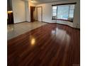 Inviting living room with a bay window, tiled entry and shiny hard wood flooring at 14989 E Pacific Pl, Aurora, CO 80014