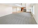 Open-concept living area with a fireplace and seamless flooring transitions at 18951 E 43Rd Ave, Denver, CO 80249