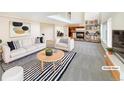 Bright living room featuring modern decor, a fireplace, and built-in bookshelves at 18951 E 43Rd Ave, Denver, CO 80249