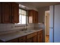 Classic kitchen featuring wood cabinets and a double sink at 9585 Brooks Dr, Arvada, CO 80004