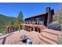 Expansive deck with cozy fire pit and views offers an inviting outdoor living space, perfect for relaxation and entertaining at 617 Hummingbird Trl, Idaho Springs, CO 80452