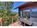 Private deck with outdoor seating provides a tranquil spot to enjoy the beautiful mountain views and fresh air at 617 Hummingbird Trl, Idaho Springs, CO 80452