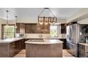 Modern kitchen boasts stainless steel appliances, granite countertops, and a center island, creating a chef's dream space at 617 Hummingbird Trl, Idaho Springs, CO 80452