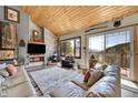 Living room with vaulted ceiling and view of mountains at 617 Hummingbird Trl, Idaho Springs, CO 80452