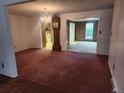 Open-concept living and dining area with an antique grandfather clock at 6961 E Arkansas Ave, Denver, CO 80224